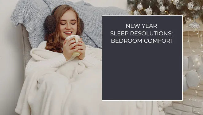 Woman relaxing in bed with a white duvet and warm drink, highlighting cozy bedroom comfort for the New Year.