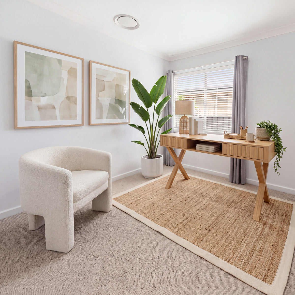 Arden 140cm Home Office Desk Natural in a study with a white boucle armchair, a jute rug and framed abstract prints, wide view