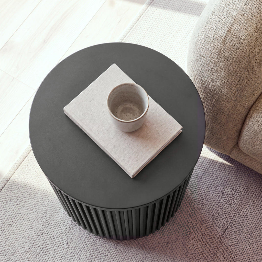 Ayla Fluted 40cm Round Side Table Black seen from above, with a cup on a linen book on the round top