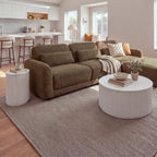 Ayla Fluted 90cm Round Coffee Table White in an open-plan living room with a kitchen behind and a matching fluted side table beside the sofa, wide view