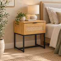 Debora 1 Drawer Bedside Table Oak, beside a bed with a table lamp on top