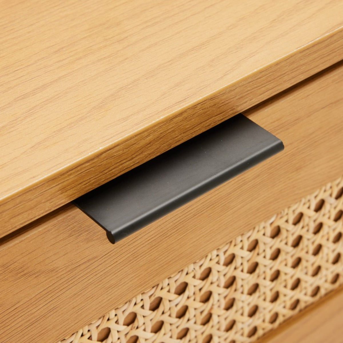 Debora 1 Drawer Bedside Table Oak, close-up of the black pull and rattan panel