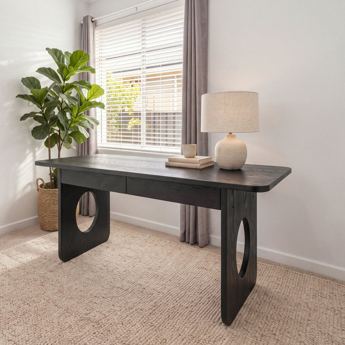 Elara 170cm Home Office Desk Black in a bright study by a window, with a table lamp and a fiddle-leaf fig
