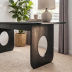 Elara 170cm Home Office Desk Black, close-up of an oval cut-out leg panel and the rounded top edge