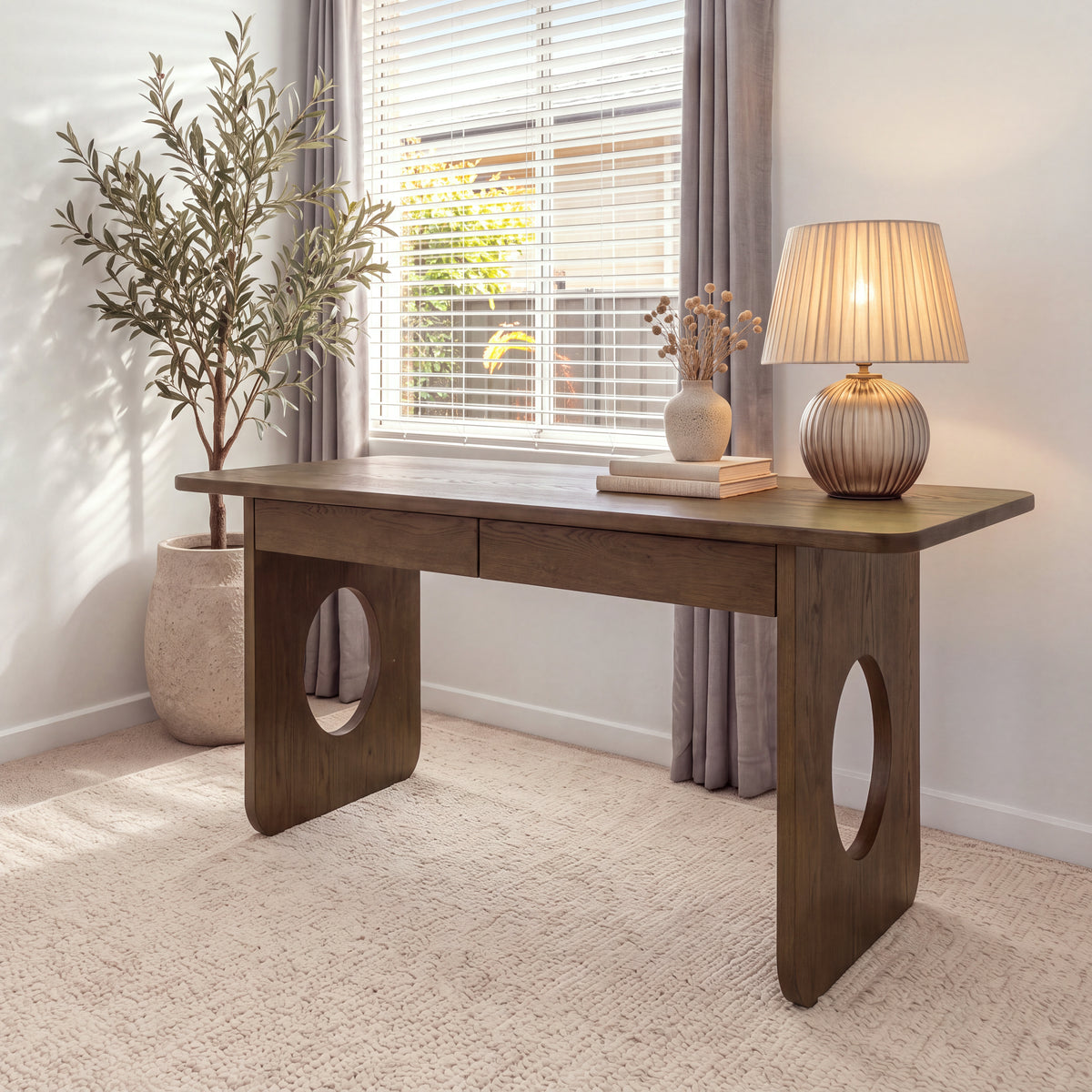 Elara 170cm Home Office Desk Walnut in a bright study by a window, with a table lamp and an olive tree