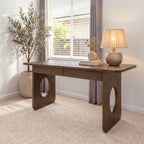 Elara 170cm Home Office Desk Walnut in a bright study by a window, with a table lamp and an olive tree
