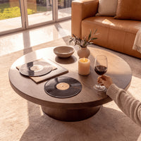 Erina 110cm Round Coffee Table Natural Walnut, close-up of the tabletop with vinyl records and a glass of wine