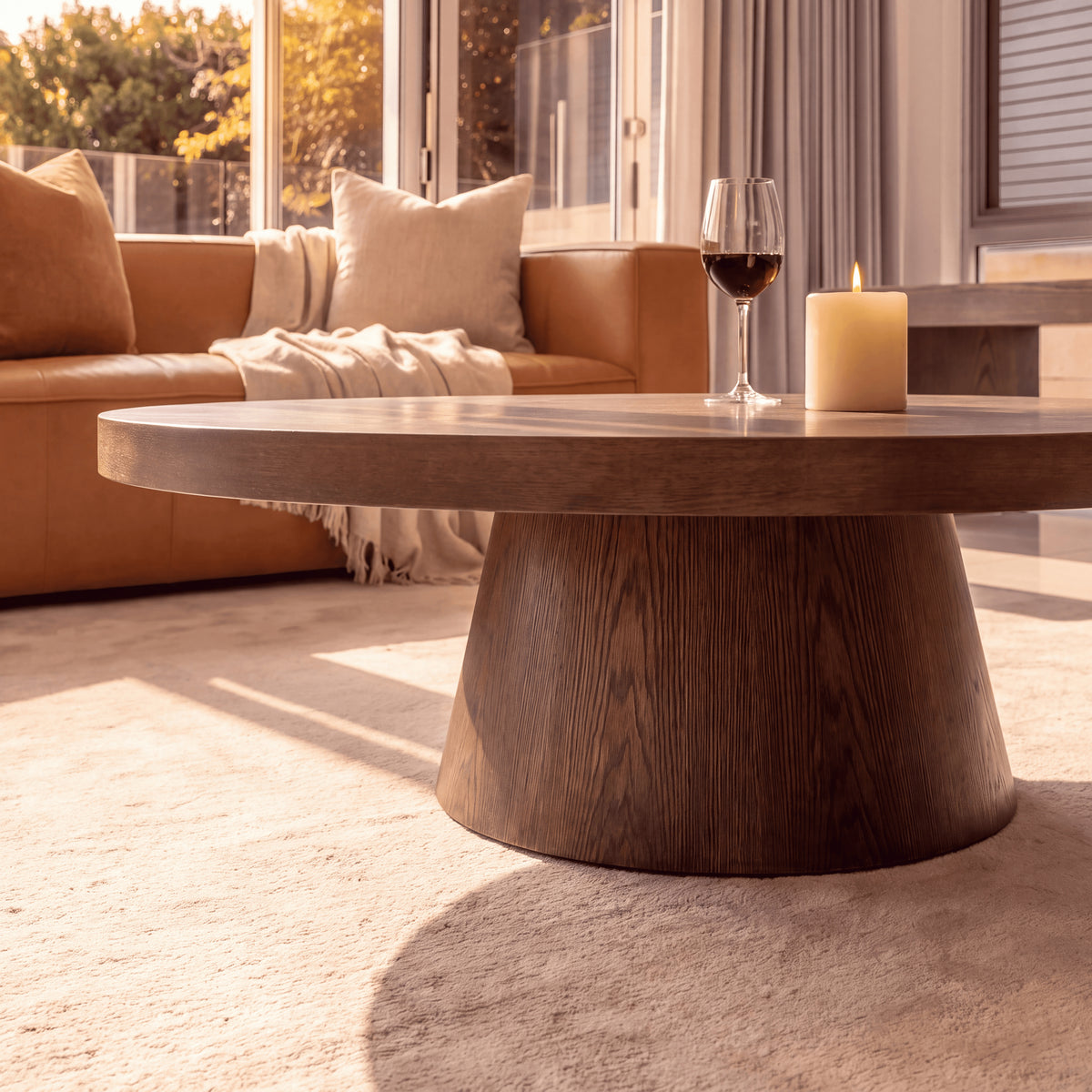 Erina 110cm Round Coffee Table Natural Walnut, close-up of the pedestal base beside a candle
