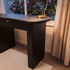 Golborne 150cm Home Office Desk Black, close-up of the end panel and curved top with a brass lamp