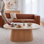 Hera 130cm Coffee Table Natural, in a living room beside a leather sofa