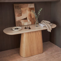 Hera 150cm Console Table Natural, styled with artwork, a bowl and a throw, three-quarter view