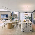 Hera 240cm Dining Table Natural, in an open-plan living and dining room beside a marble kitchen island