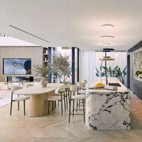 Hera 240cm Dining Table Natural, in an open-plan living and dining room beside a marble kitchen island