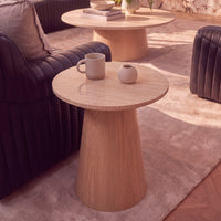 Hera 55cm Round Side Table Natural, raised view of the round tabletop beside a sofa