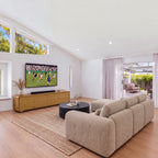 Hudson Jenny 220cm ETU Entertainment TV Unit Natural in a living room with high windows, a sofa and a round coffee table, wide view