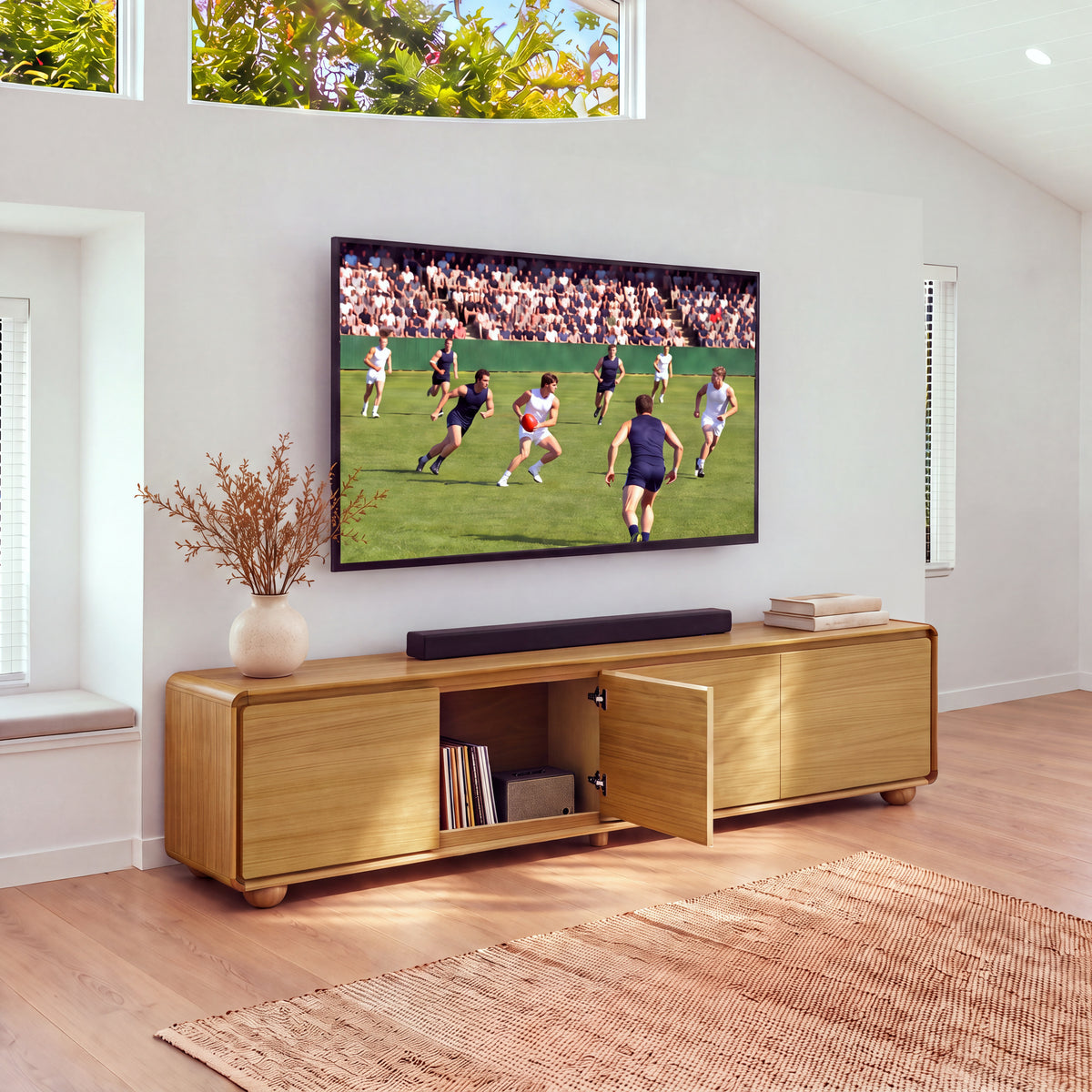 Hudson Jenny 220cm ETU Entertainment TV Unit Natural with one door open showing books and a media box inside, under a wall-mounted TV