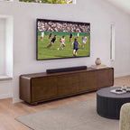 Hudson Jenny 220cm ETU Entertainment TV Unit Walnut under a wall-mounted TV with a soundbar on top, a fluted round coffee table and rug in front