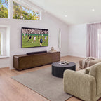 Hudson Jenny 220cm ETU Entertainment TV Unit Walnut in a living room with a high window, a sofa and a fluted round coffee table, wide view