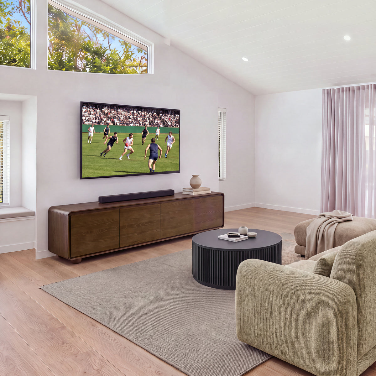 Hudson Jenny 220cm ETU Entertainment TV Unit Walnut in a living room with a high window, a sofa and a fluted round coffee table, wide view