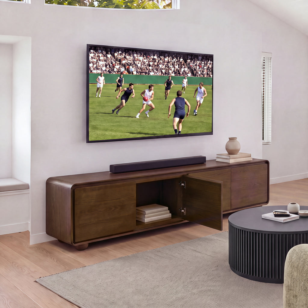 Hudson Jenny 220cm ETU Entertainment TV Unit Walnut with one door open showing books inside, under a wall-mounted TV