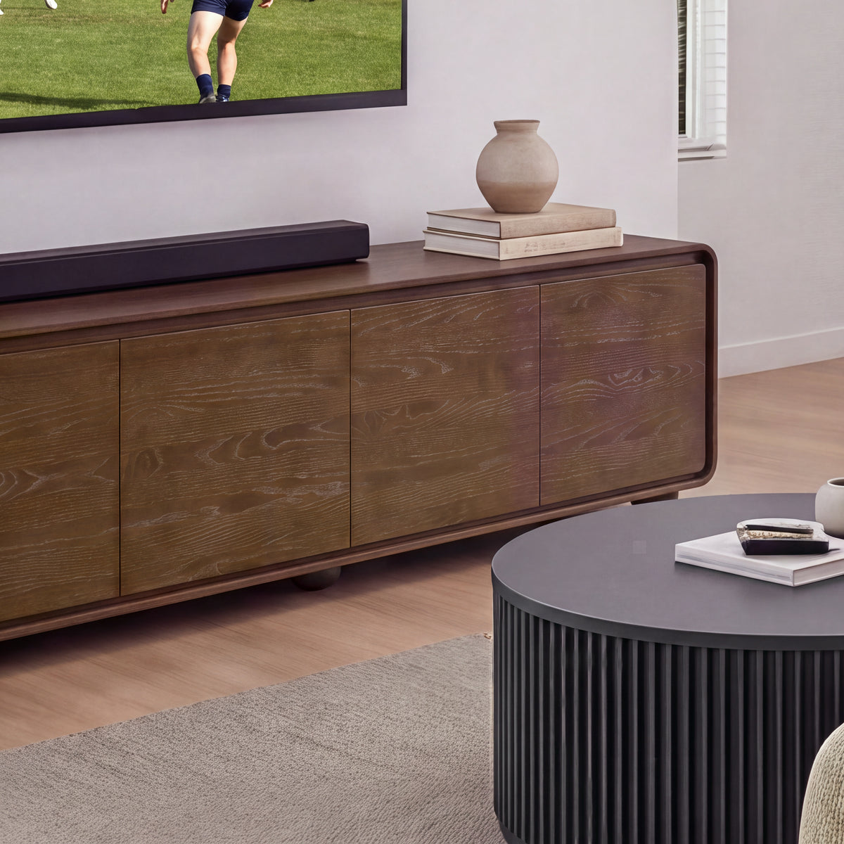 Hudson Jenny 220cm ETU Entertainment TV Unit Walnut, close view of the doors and rounded corners, with a vase and books on top