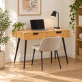 Jinan 110cm Study Desk Oak, in a home office with a chair and laptop