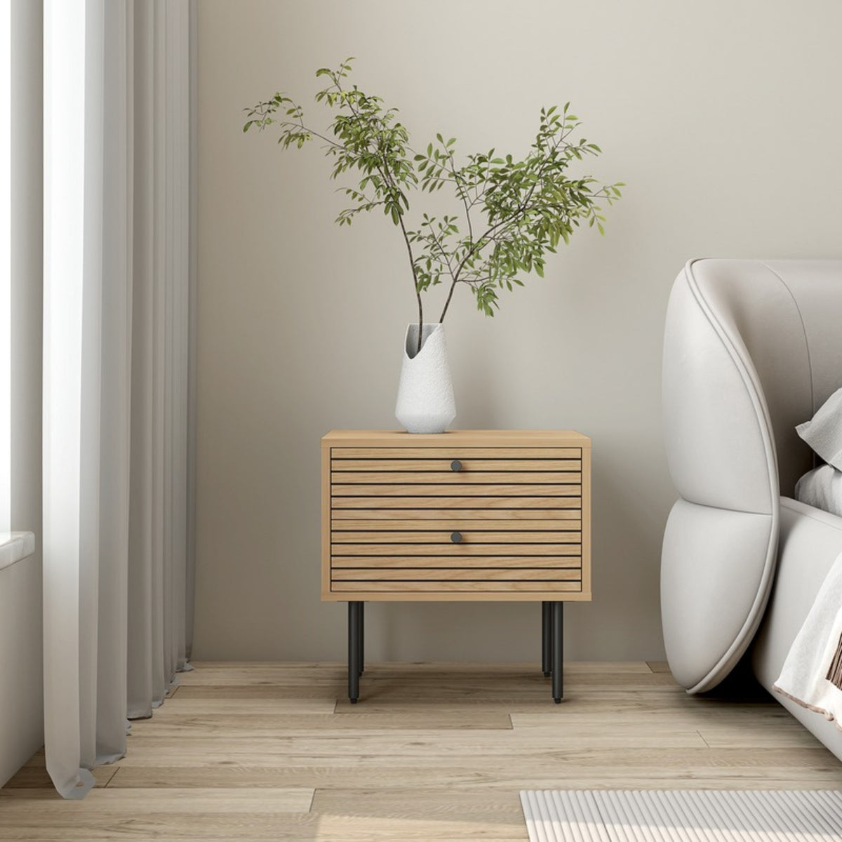 Line 2 Drawer Bedside Table Oak and Black, beside a sofa with a potted plant on top