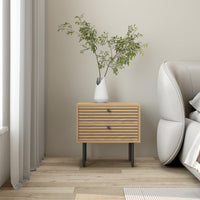 Line 2 Drawer Bedside Table Oak and Black, beside a sofa with a potted plant on top