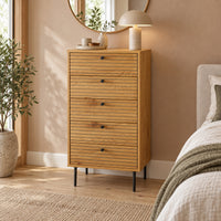 Line 50cm Tallboy Chest of 5 Drawers Oak and Black, in a bedroom beneath a round mirror