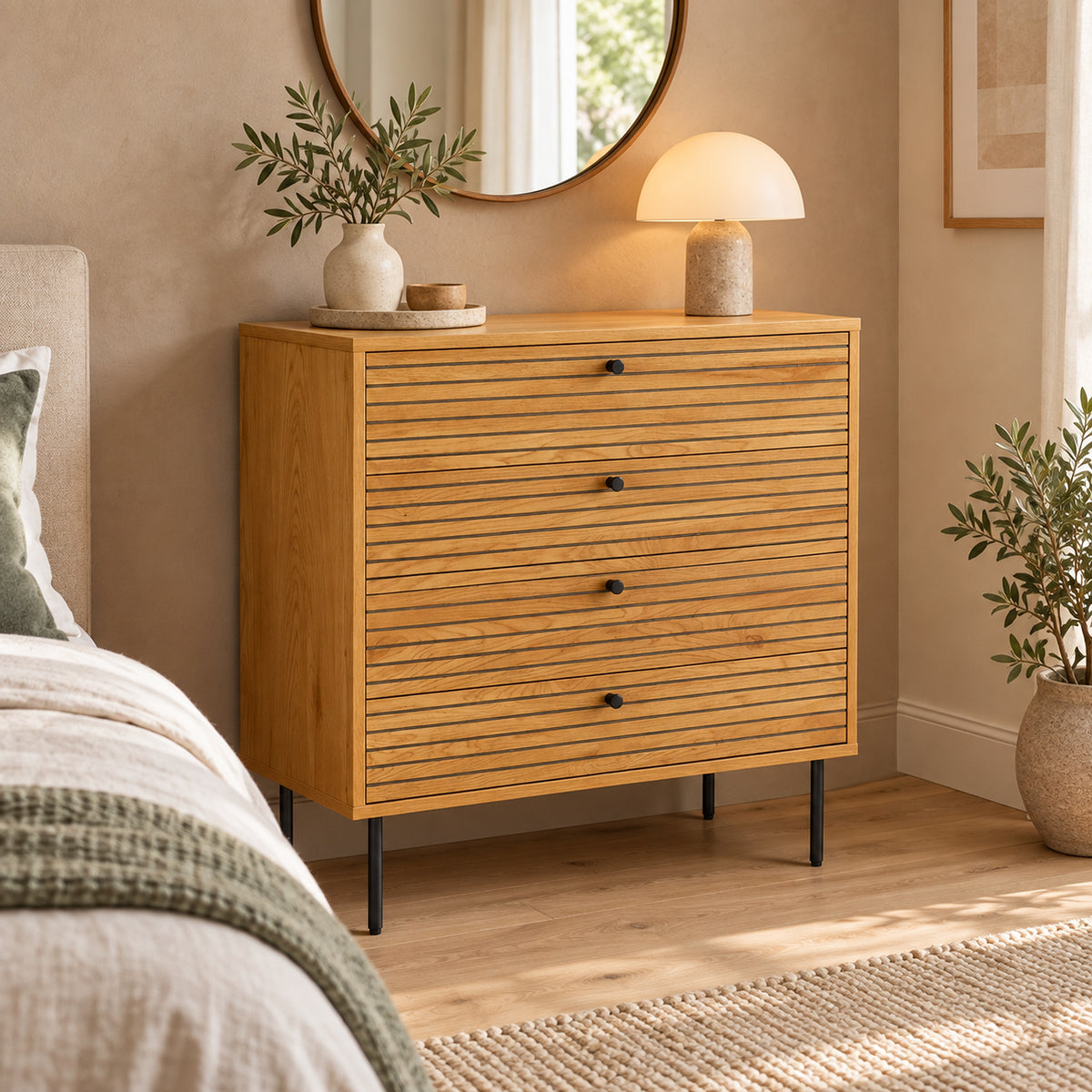 Line 80cm Tallboy Chest of 4 Drawers Oak and Black, in a bedroom beneath a round mirror