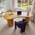 Marty 170cm Home Office Desk Natural seen from above, showing the curved kidney-shaped top with a laptop, books and a lamp