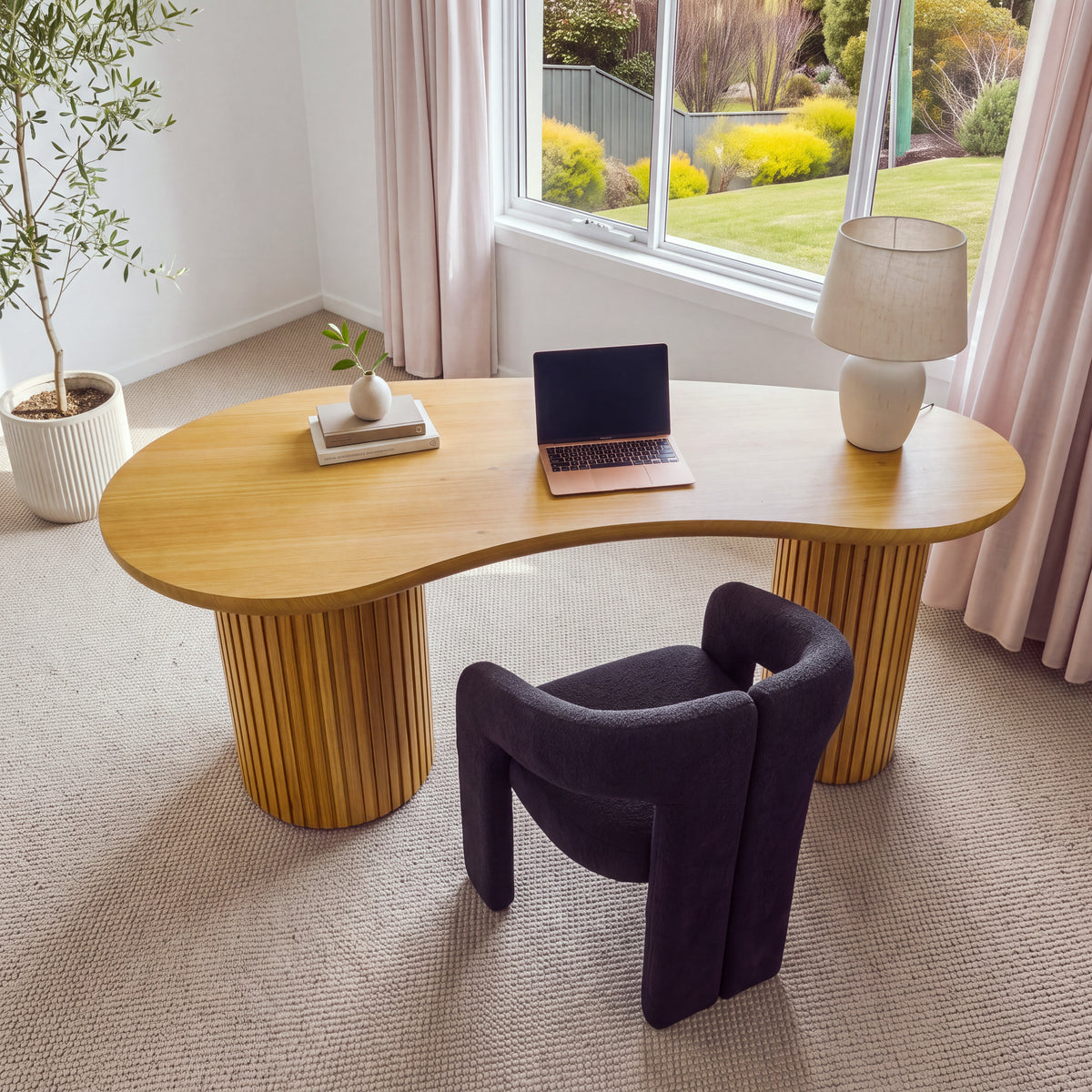 Marty 170cm Home Office Desk Natural seen from above, showing the curved kidney-shaped top with a laptop, books and a lamp