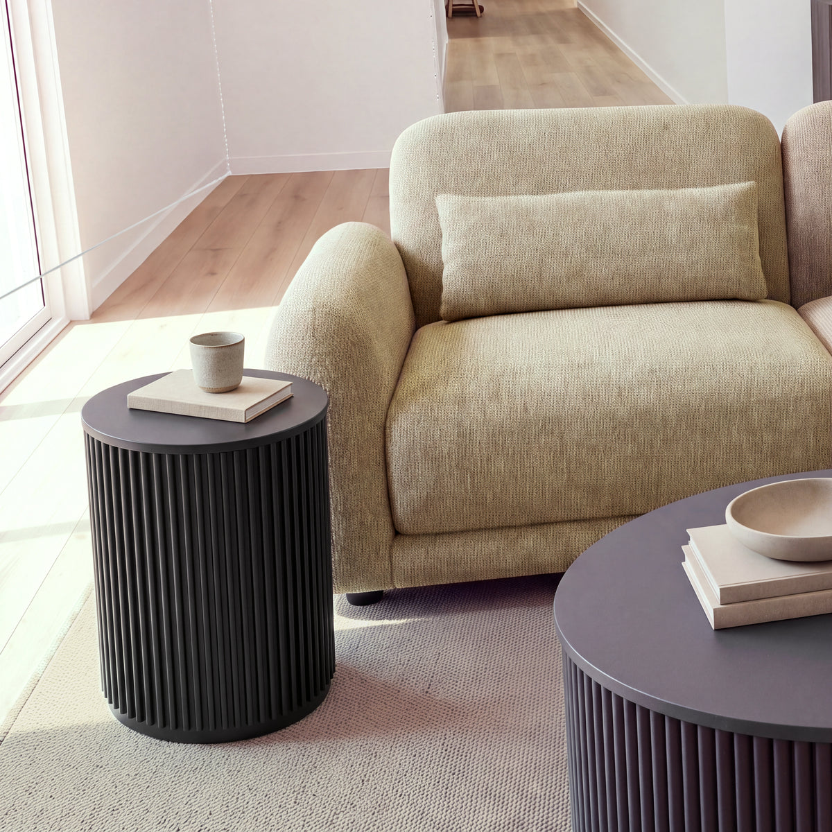Paulie 270cm 3 Seater Modular Sofa with Ottoman Latte, close-up of the left arm, seat and lumbar cushion beside a round side table