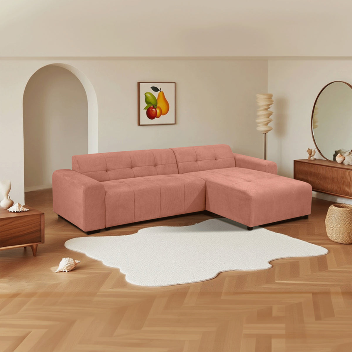 Quinn 4 Seater Upholstered Sofa with Reversible Chaise Blush Pink, styled in a living room, front three-quarter view