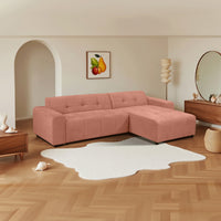 Quinn 4 Seater Upholstered Sofa with Reversible Chaise Blush Pink, styled in a living room, front three-quarter view
