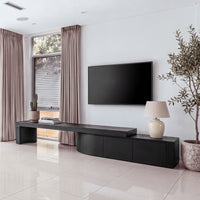 Ruvos 213-280cm Extendable ETU Entertainment TV Unit Black, beneath a wall-mounted TV in a living room