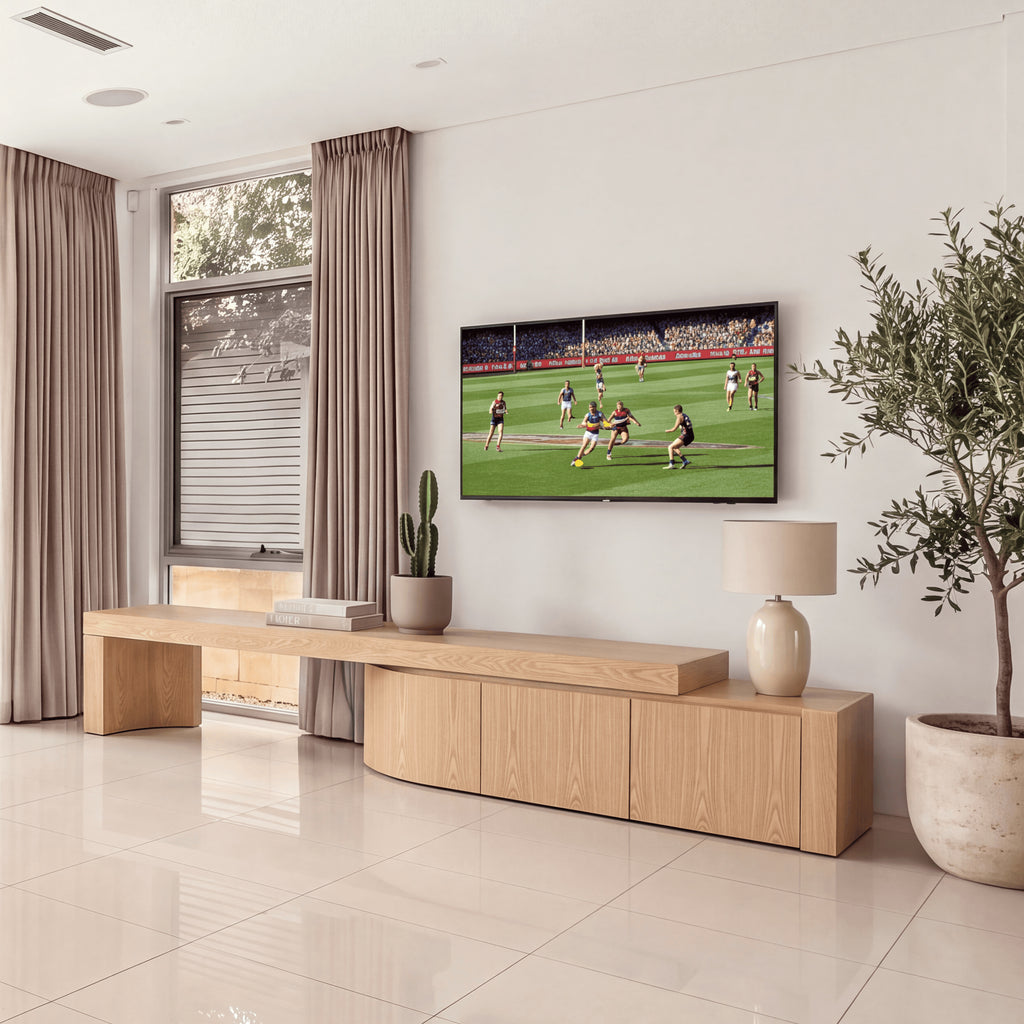 Ruvos 213-280cm Extendable ETU Entertainment TV Unit Natural Oak, beneath a wall-mounted TV in a living room