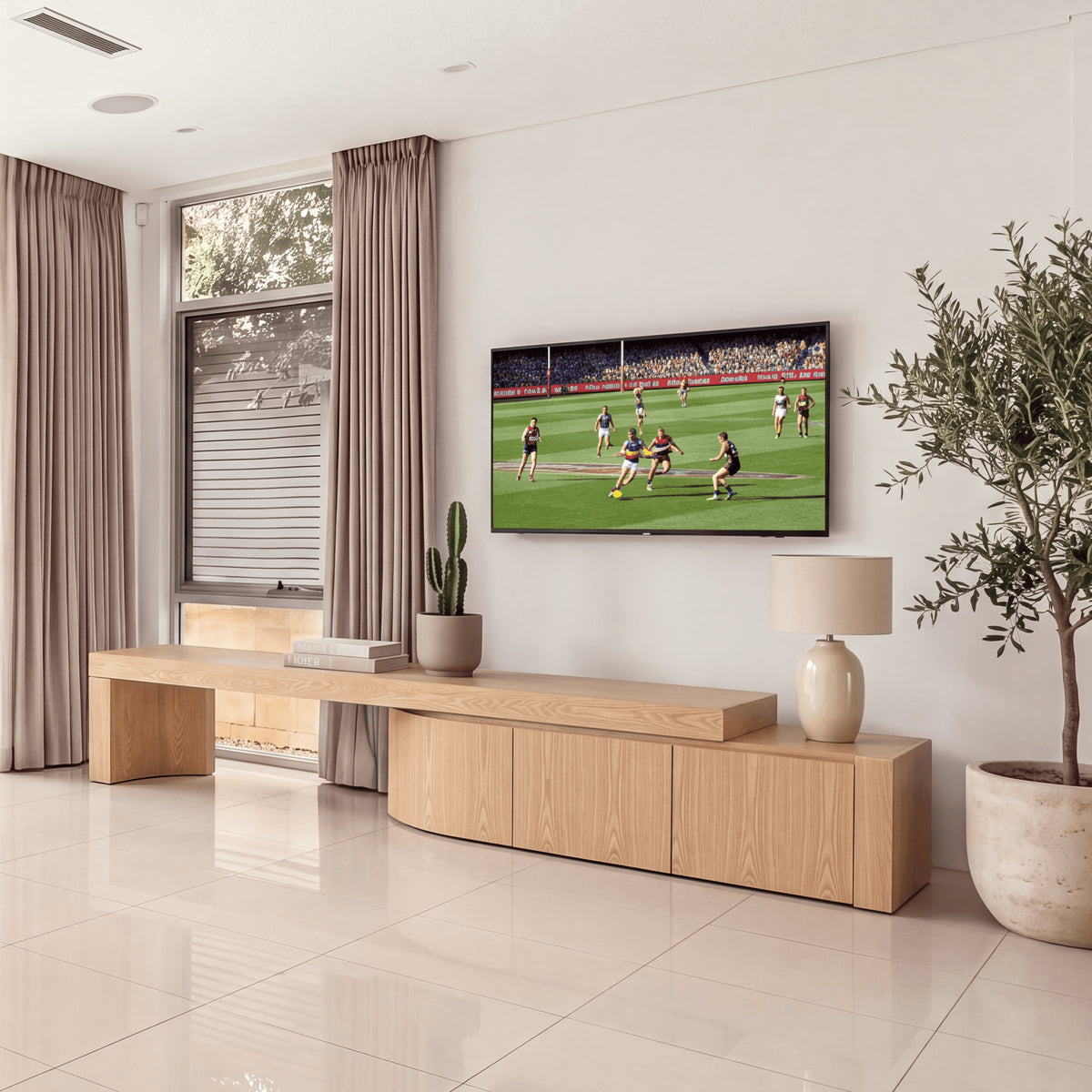 Ruvos 213-280cm Extendable ETU Entertainment TV Unit Natural Oak, beneath a wall-mounted TV in a living room