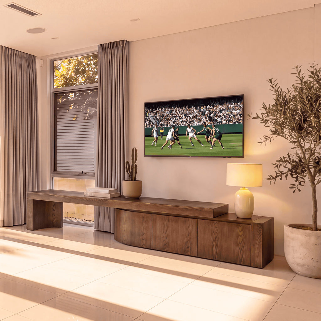 Ruvos 213-280cm Extendable ETU Entertainment TV Unit Walnut, beneath a wall-mounted TV in a living room