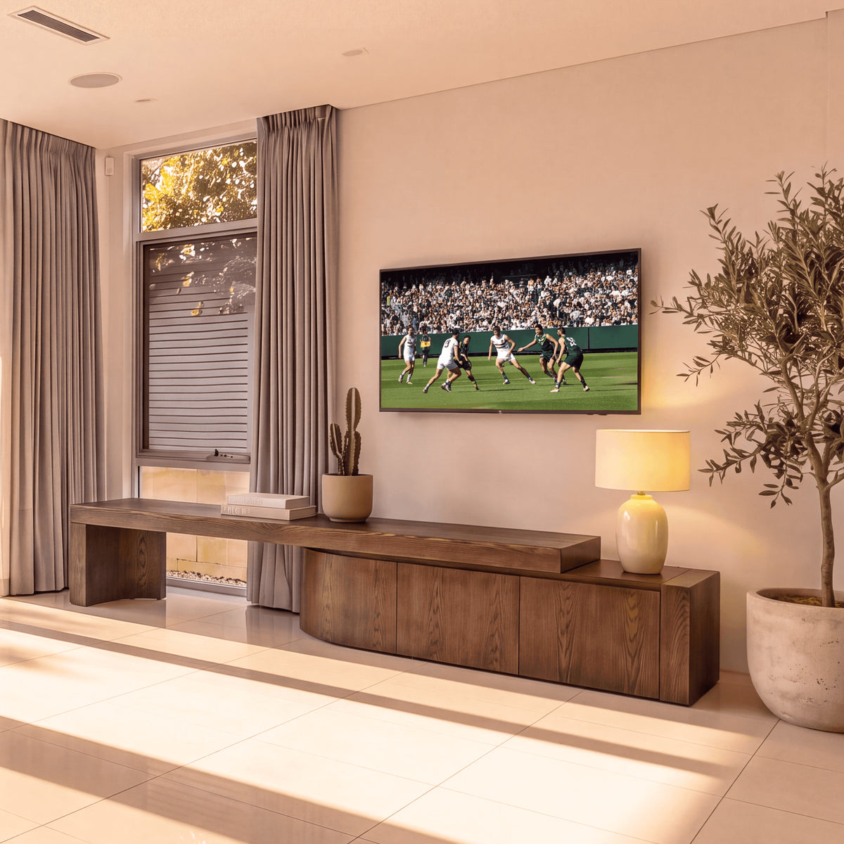Ruvos 213-280cm Extendable ETU Entertainment TV Unit Walnut, beneath a wall-mounted TV in a living room