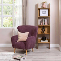 Scala 50cm Bookshelf Oak, in a living room beside a velvet armchair
