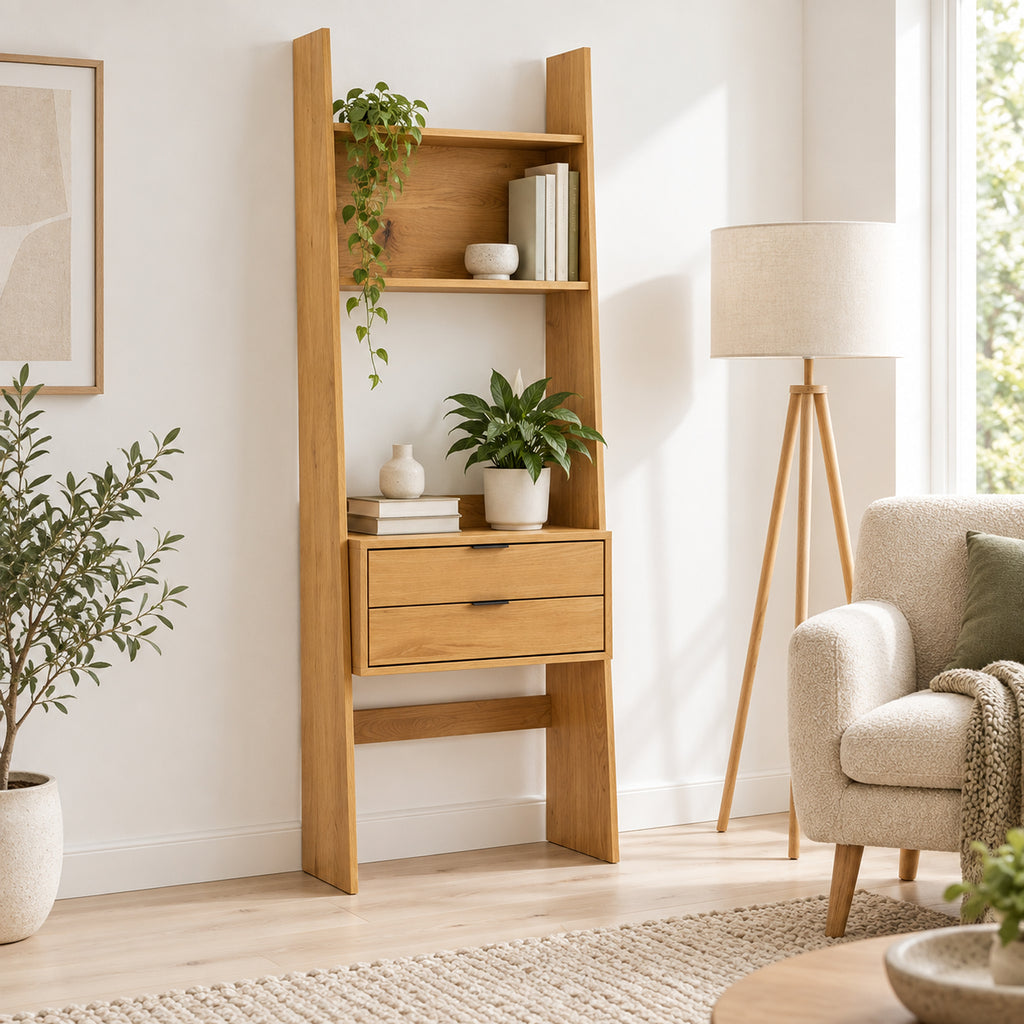 Scala 60cm 2 Drawer Bookshelf Oak, in a living room beside an armchair and floor lamp