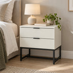 Svana 2 Drawer Bedside Table White, beside a bed with a table lamp on top