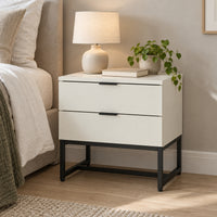 Svana 2 Drawer Bedside Table White, beside a bed with a table lamp on top