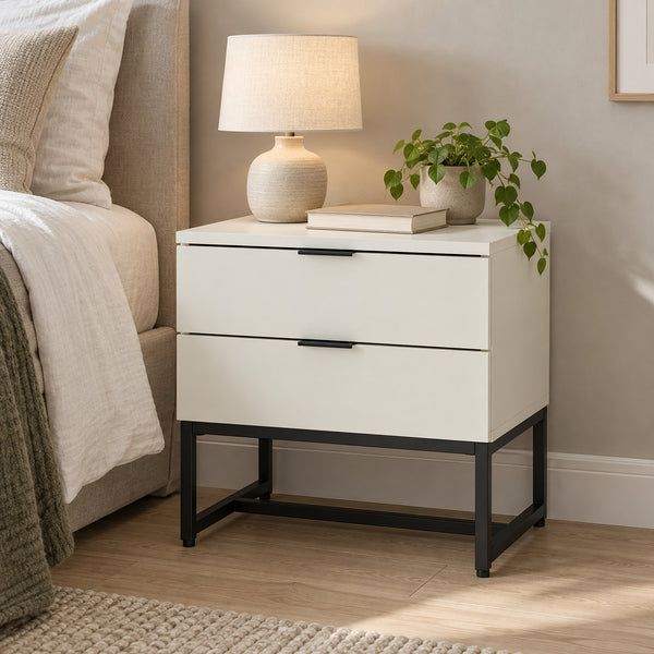 Svana 2 Drawer Bedside Table White, beside a bed with a table lamp on top