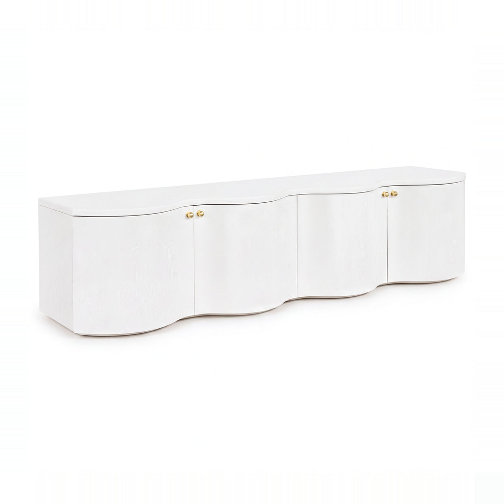 Wave 215cm white four-door entertainment unit with a curved wave front and brass knobs, angled view on a white background
