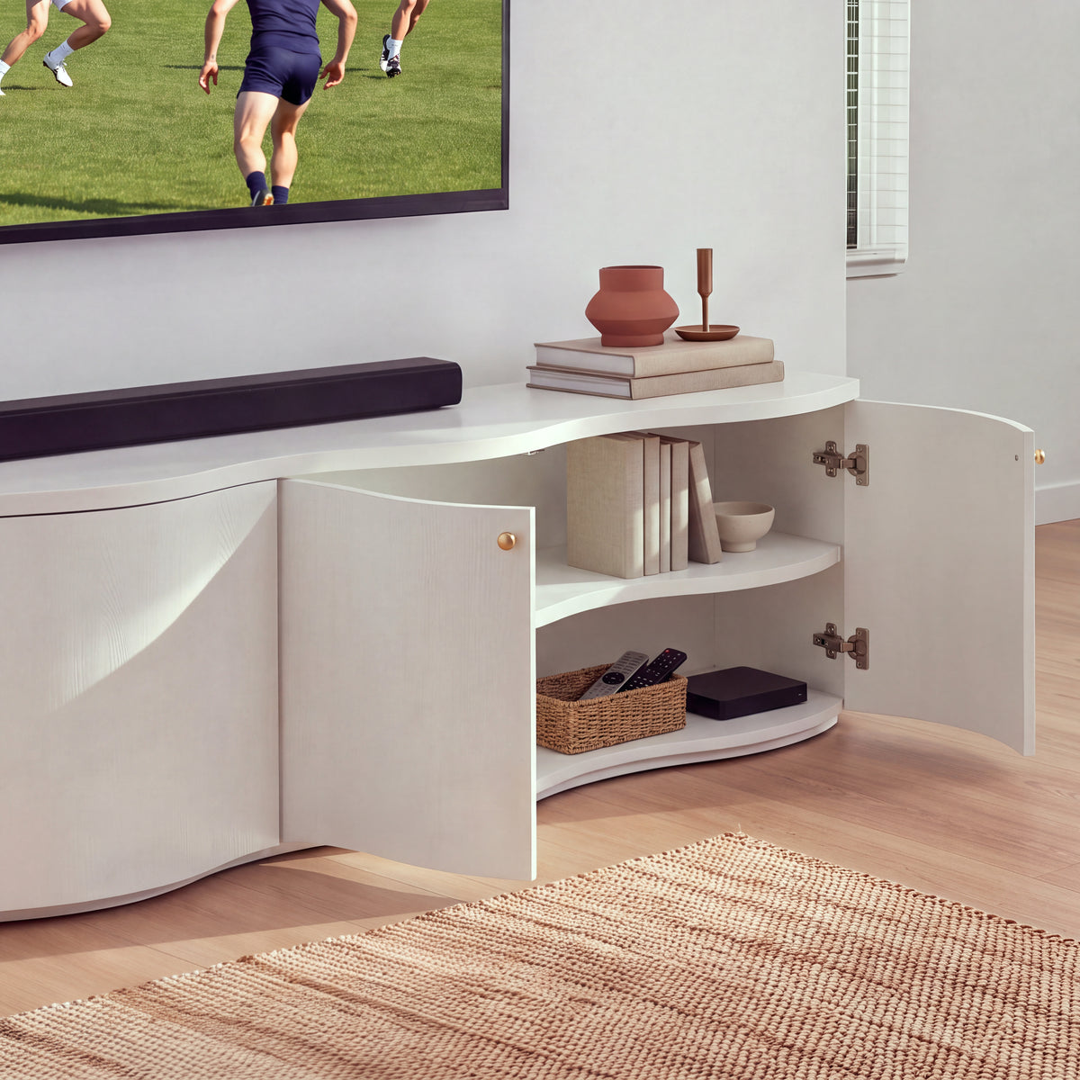 Wave white entertainment unit with its right-hand doors open showing the interior shelf, in a living room