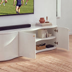 Wave white entertainment unit with its right-hand doors open showing the interior shelf, in a living room